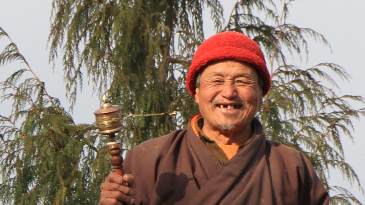 man with prayer wheel, Bhutan