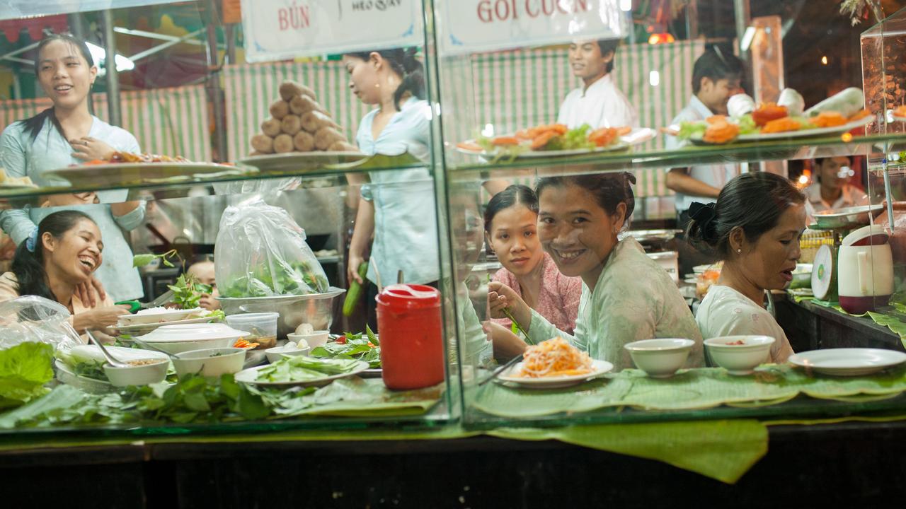 Ladies smiling sitting by the window at a Vietnam restaurant