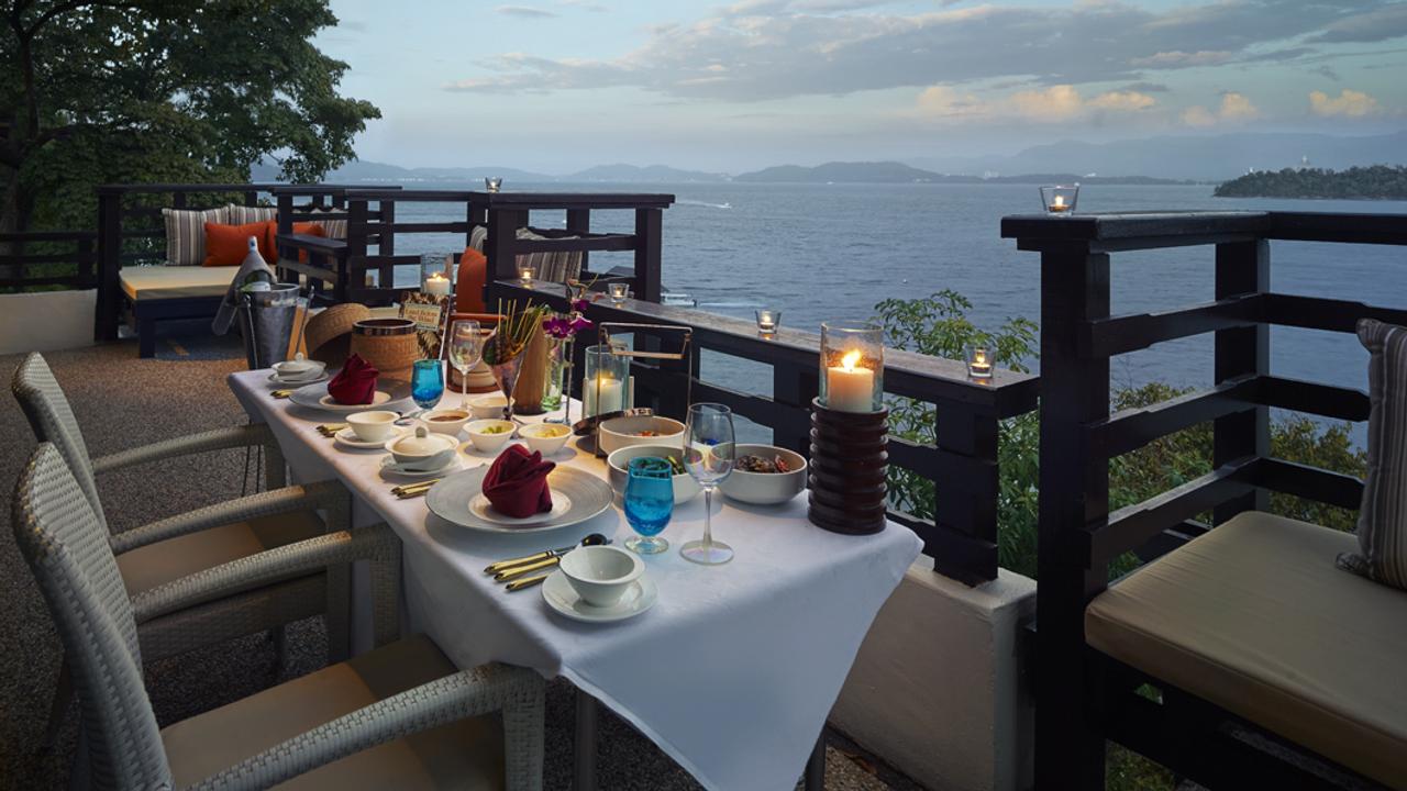Table overlooking the sea at sunset at Gaya Island Resort