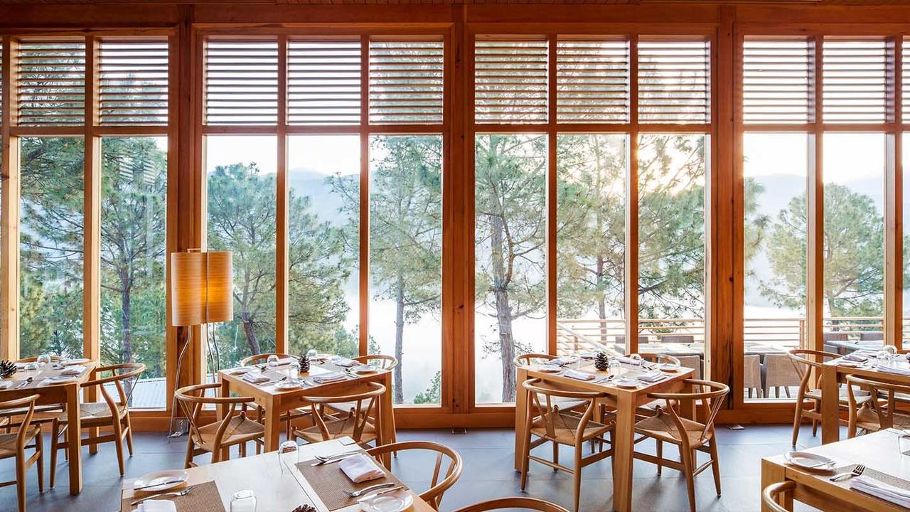 Restaurant with large picture windows at Dhensa Boutique Resort