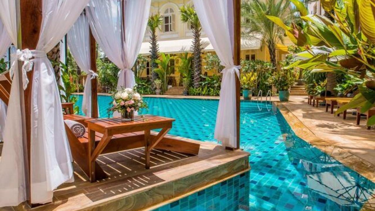 Pool and sun lounger at palace Gate Hotel