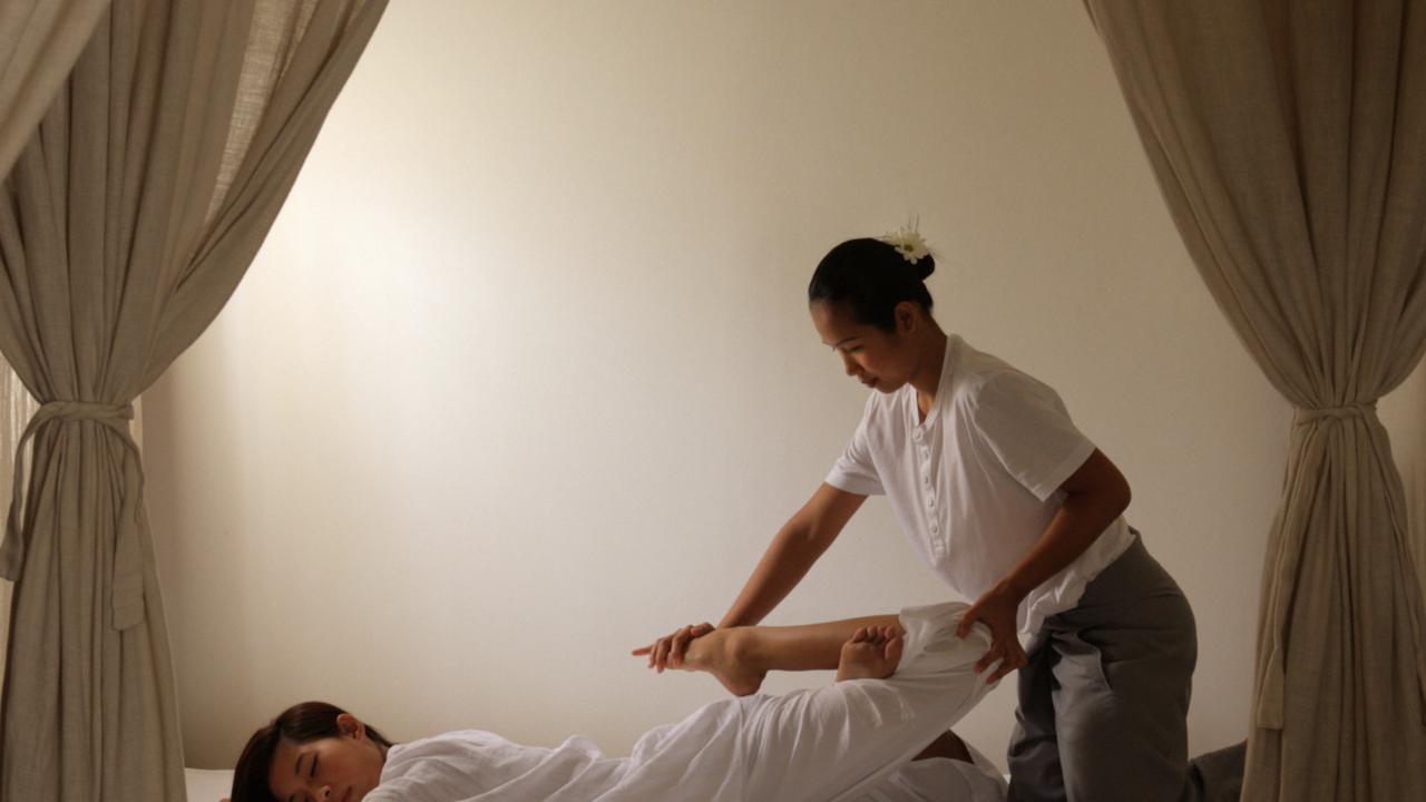 Woman having Thai massage at Como Metropolitan Bangkok Spa