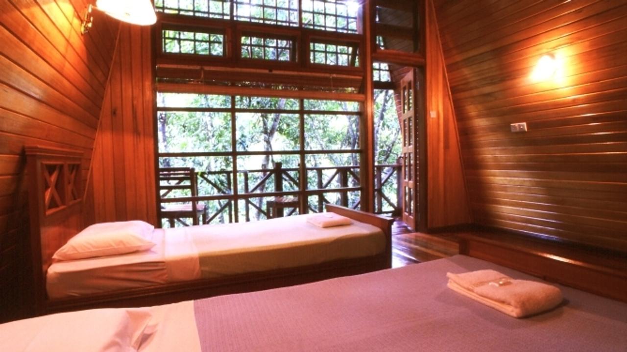 Wooden cabin with twin beds at Tabin Wildlife Resort