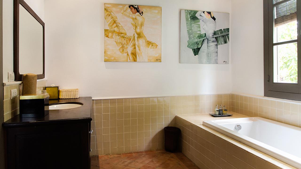Bathroom with art at Satri House