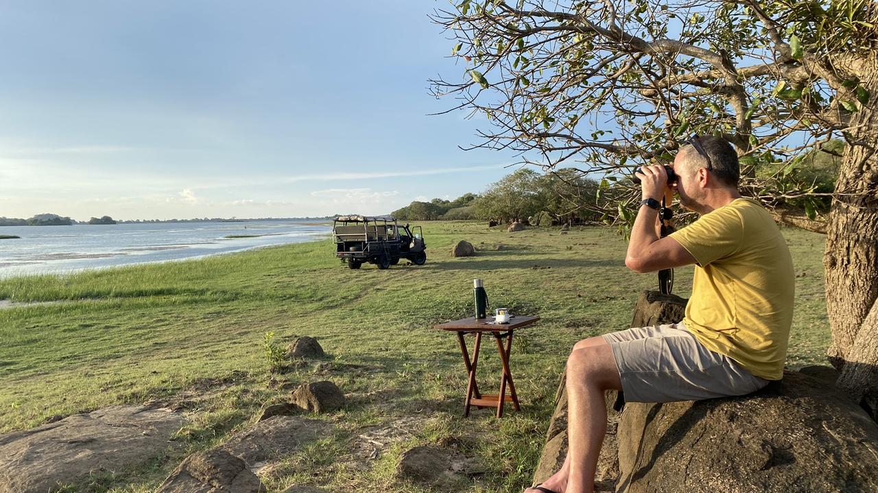 Man looking through binoculars in Wasgamuwa National Park