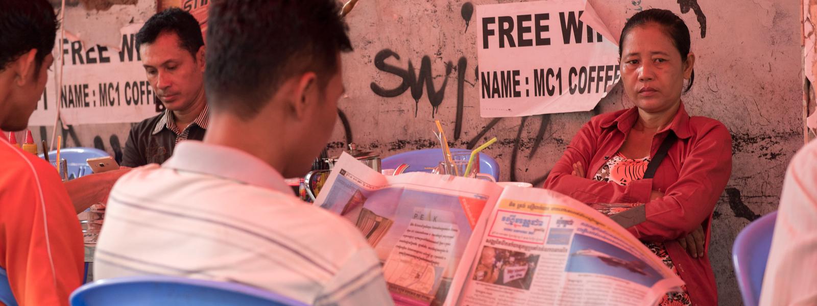 Man reading paper in Phnom Penh