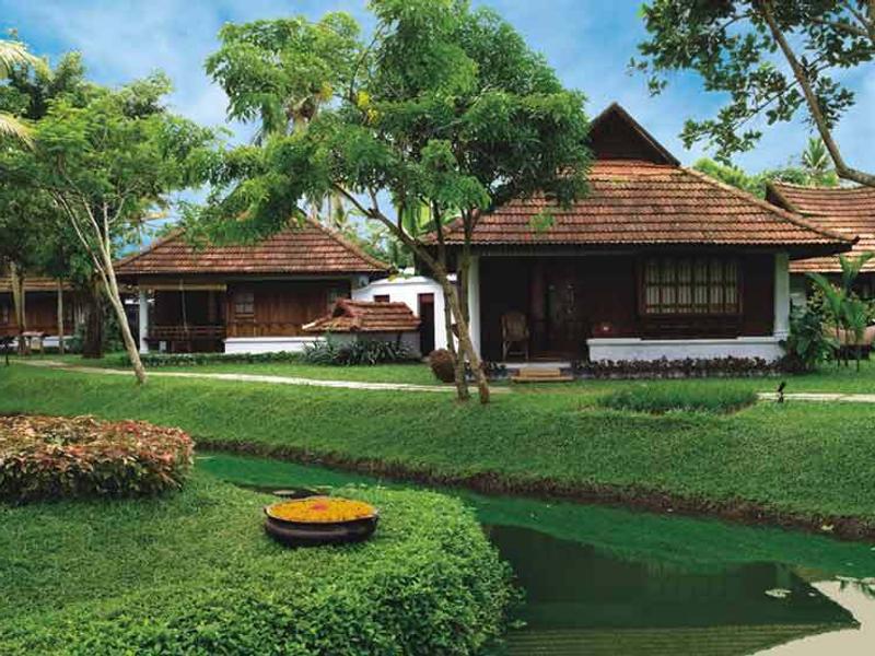 Villas in green gardens at Kumarakom Lake Resort