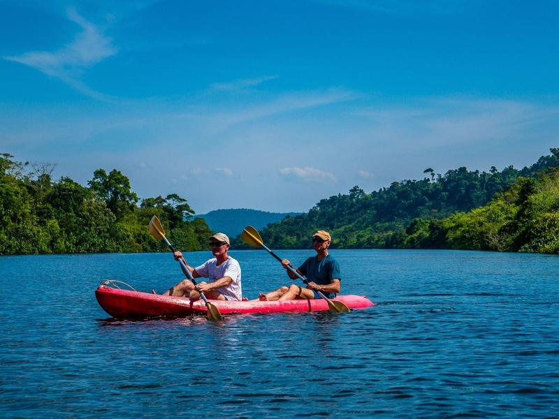 Two men kayaking on a river